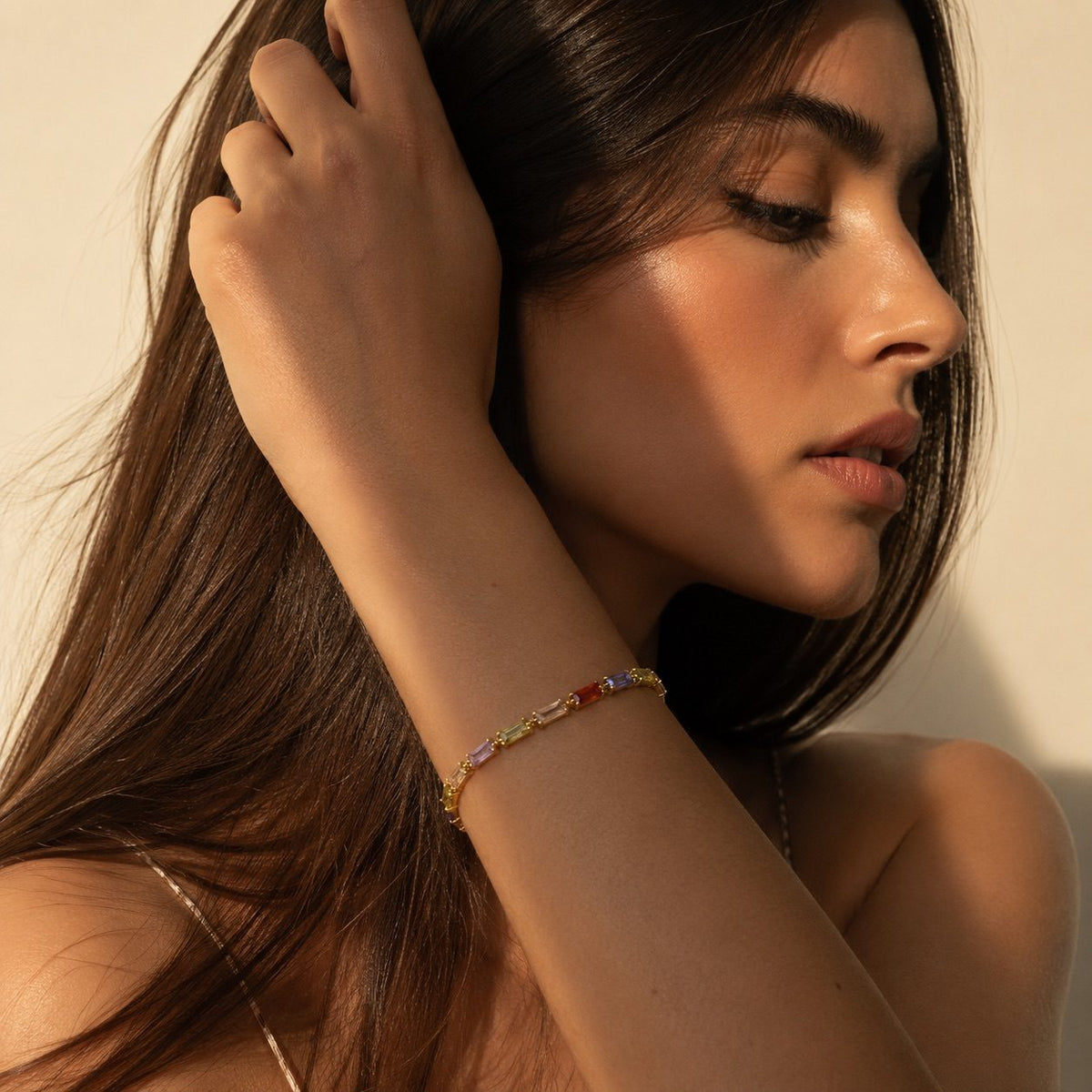 multicolor baguette CZ bracelet featuring rainbow cubic zirconia stones in a polished gold-tone setting