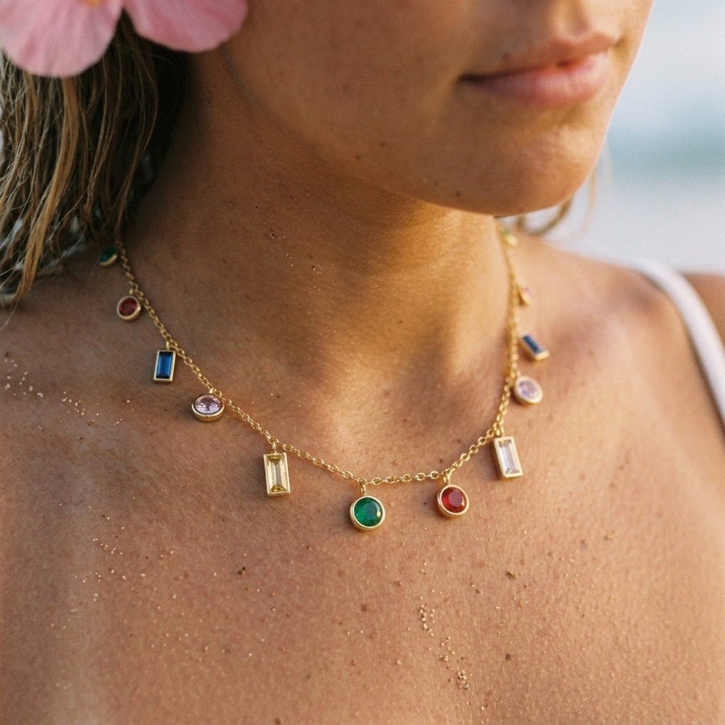 multicolor gemstone charm necklace with colourful bezel-set stones on a delicate gold chain