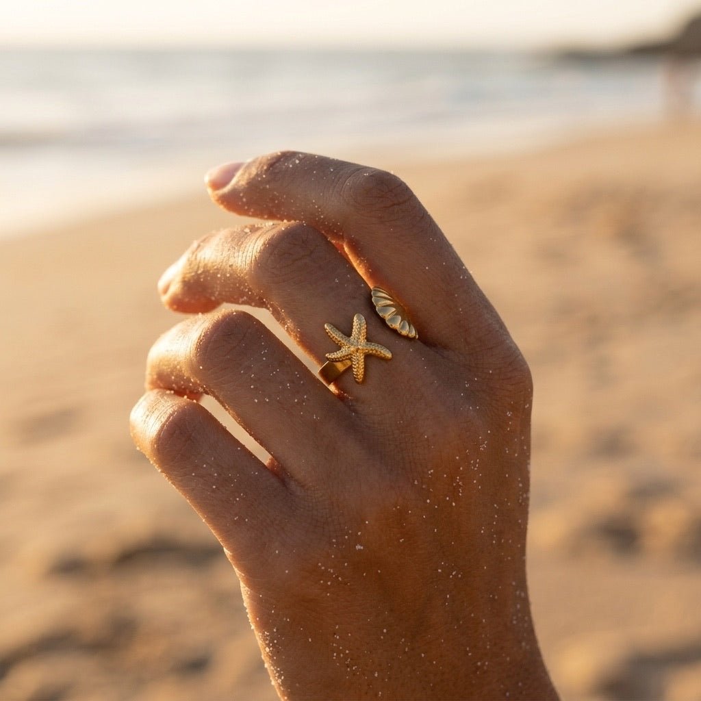 nautical gold ring with starfish and seashell motifs in an open coastal design
