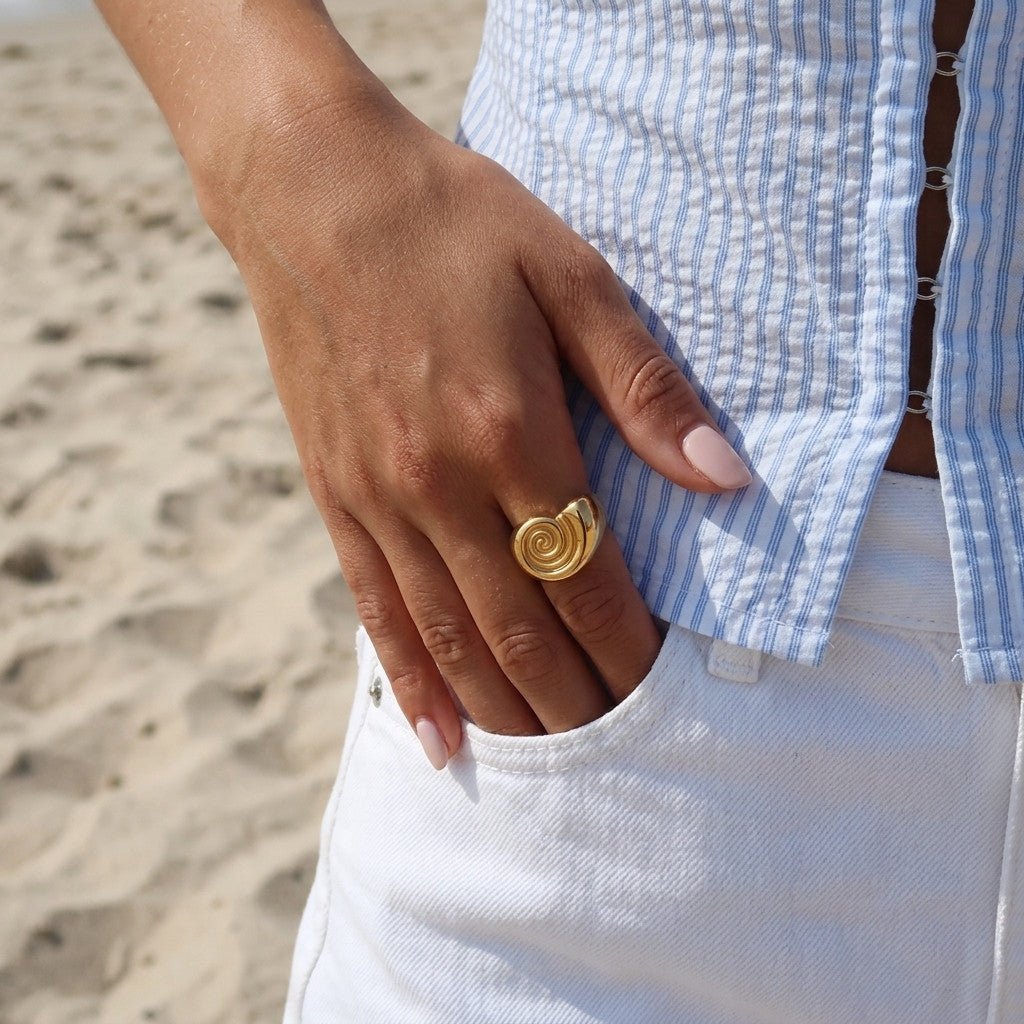 nautilus shell gold ring with a spiral inspired design and polished statement finish