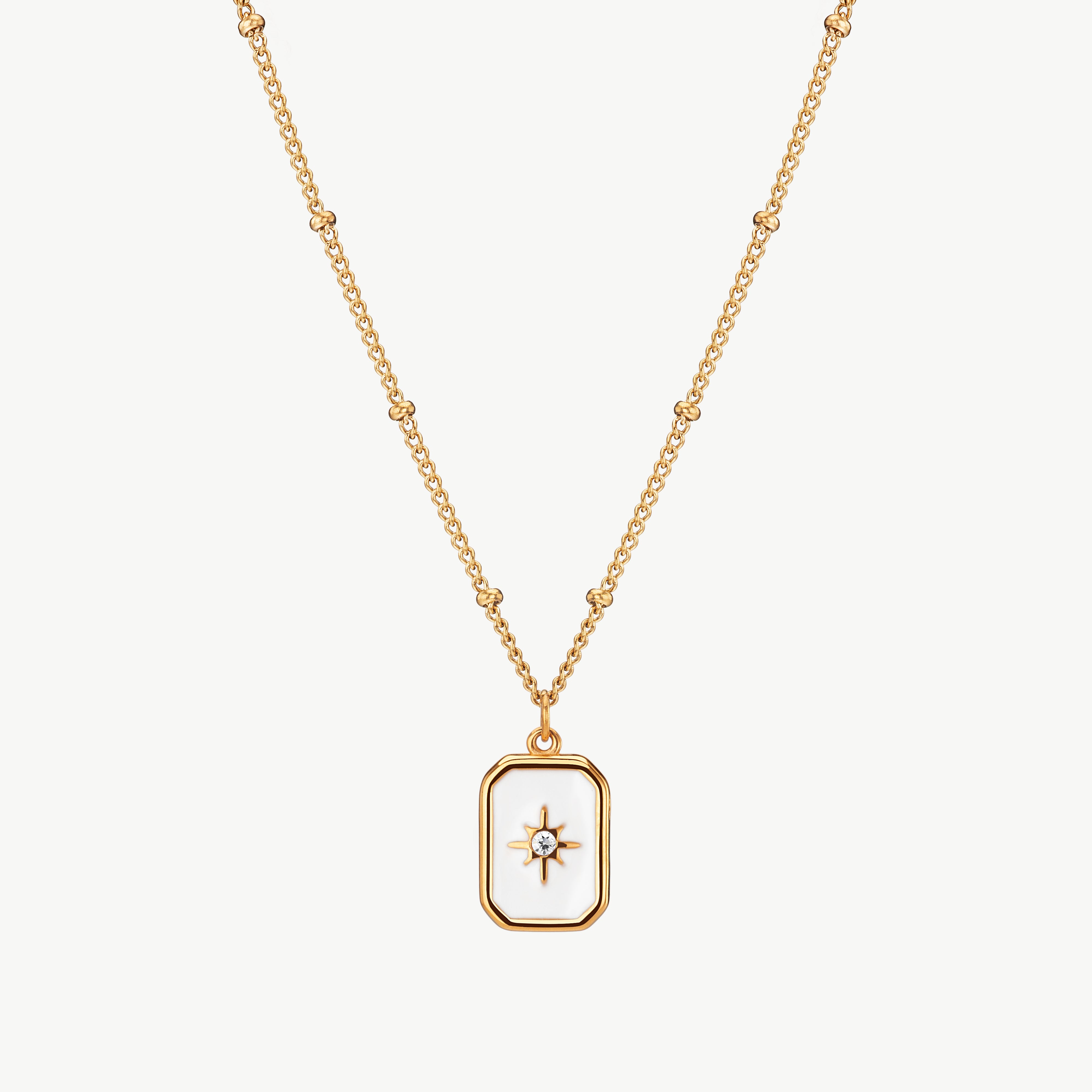north star necklace in gold with engraved star detail, celestial charm necklace with a small compass-style pendant centered on the chain and star pendant necklace
