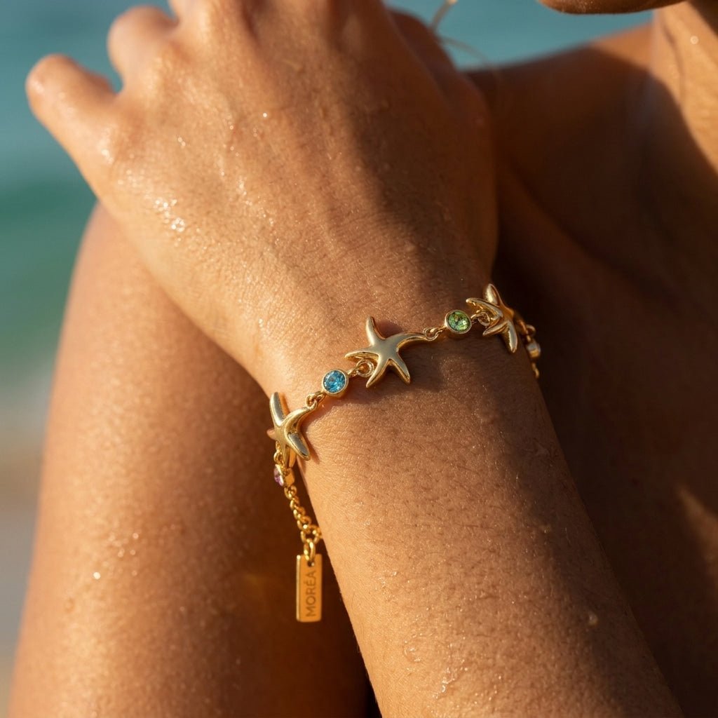 gold ocean inspired bracelet with starfish charms 