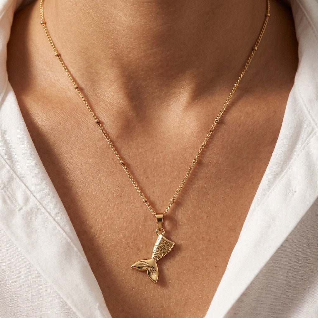 ocean inspired mermaid necklace featuring a sculpted gold tail charm