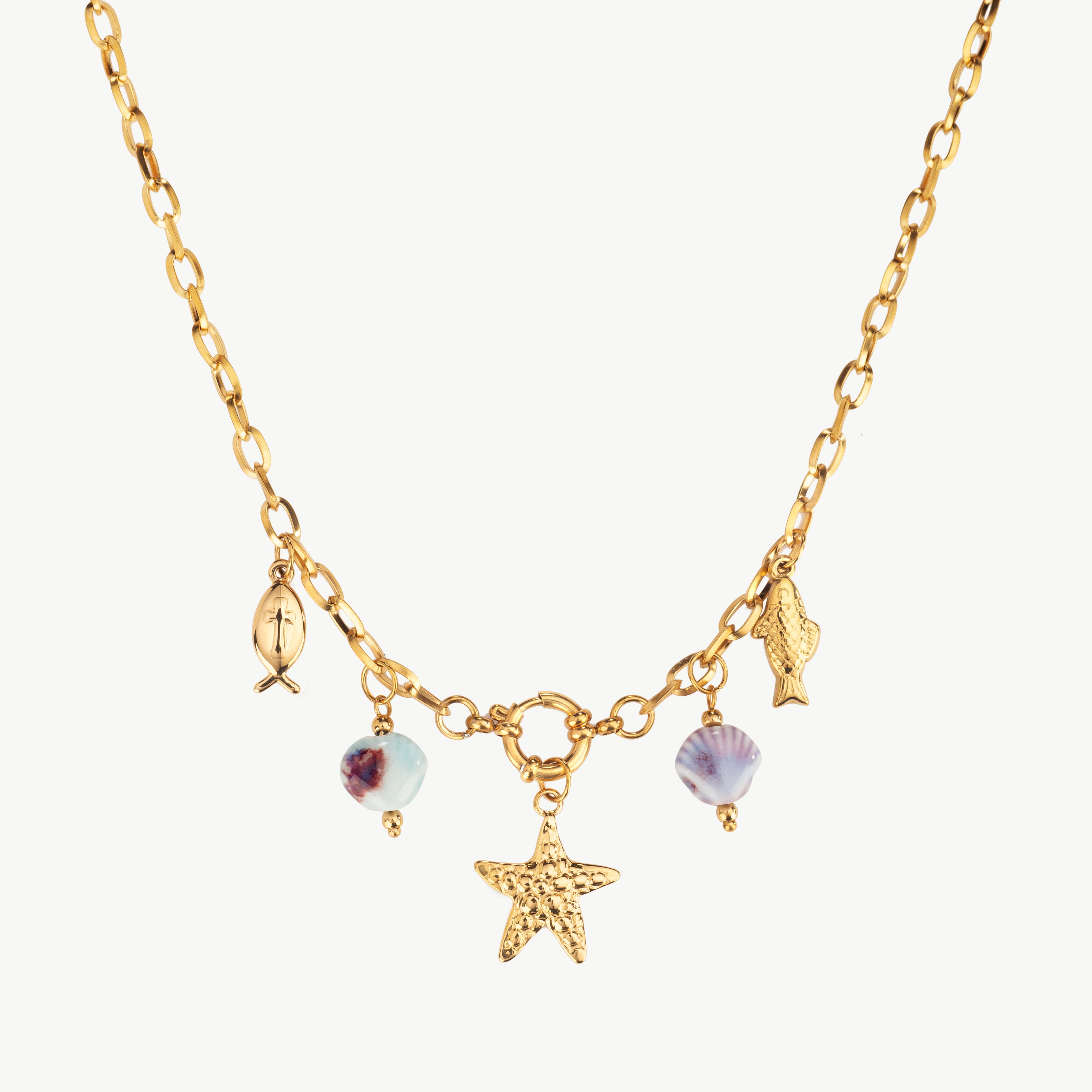 ocean necklace in gold with sea star and fish charms, multi charm gold necklace with coastal-inspired details arranged along the chain