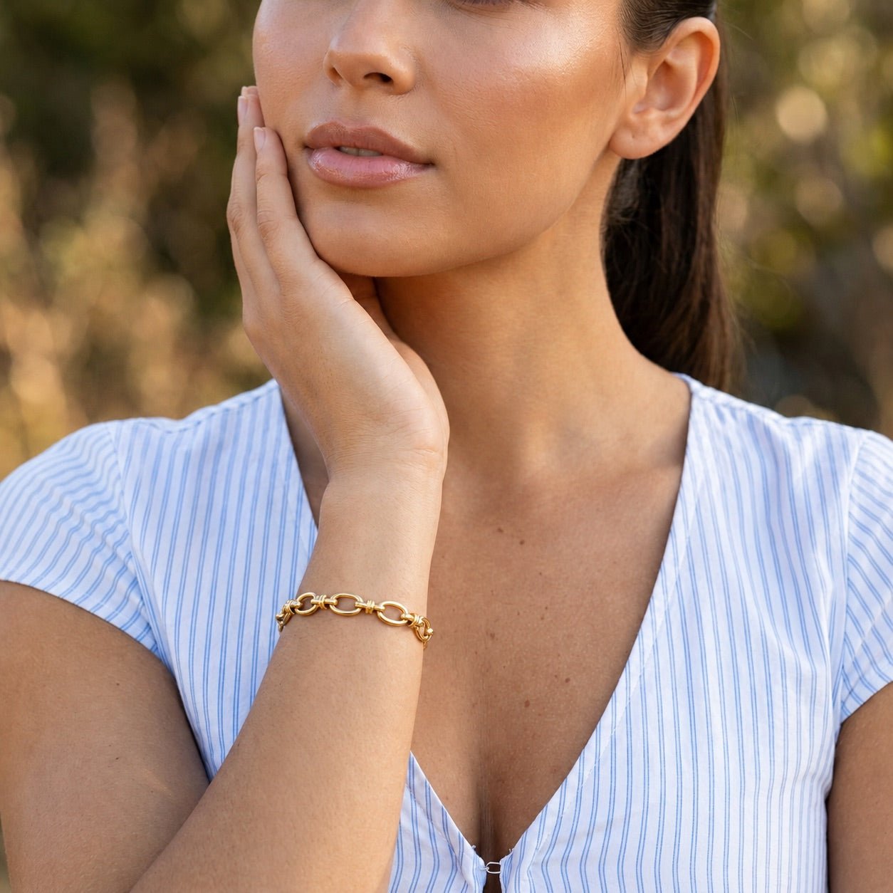 gold open link bracelet with polished oval details 