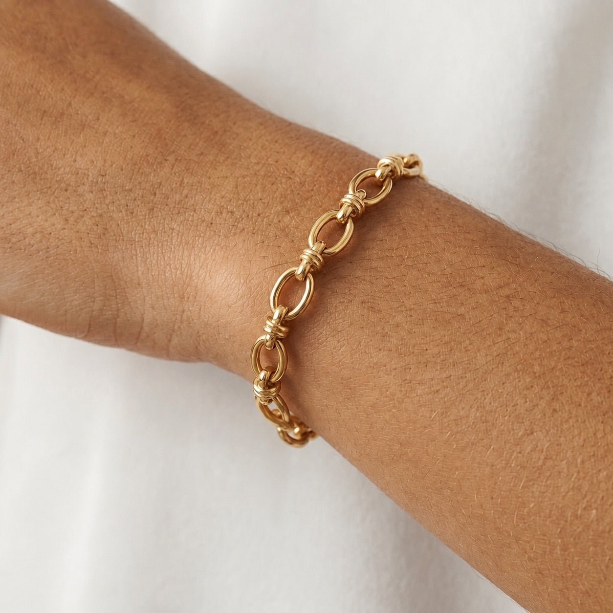 gold oval link bracelet with decorative wrapped connectors