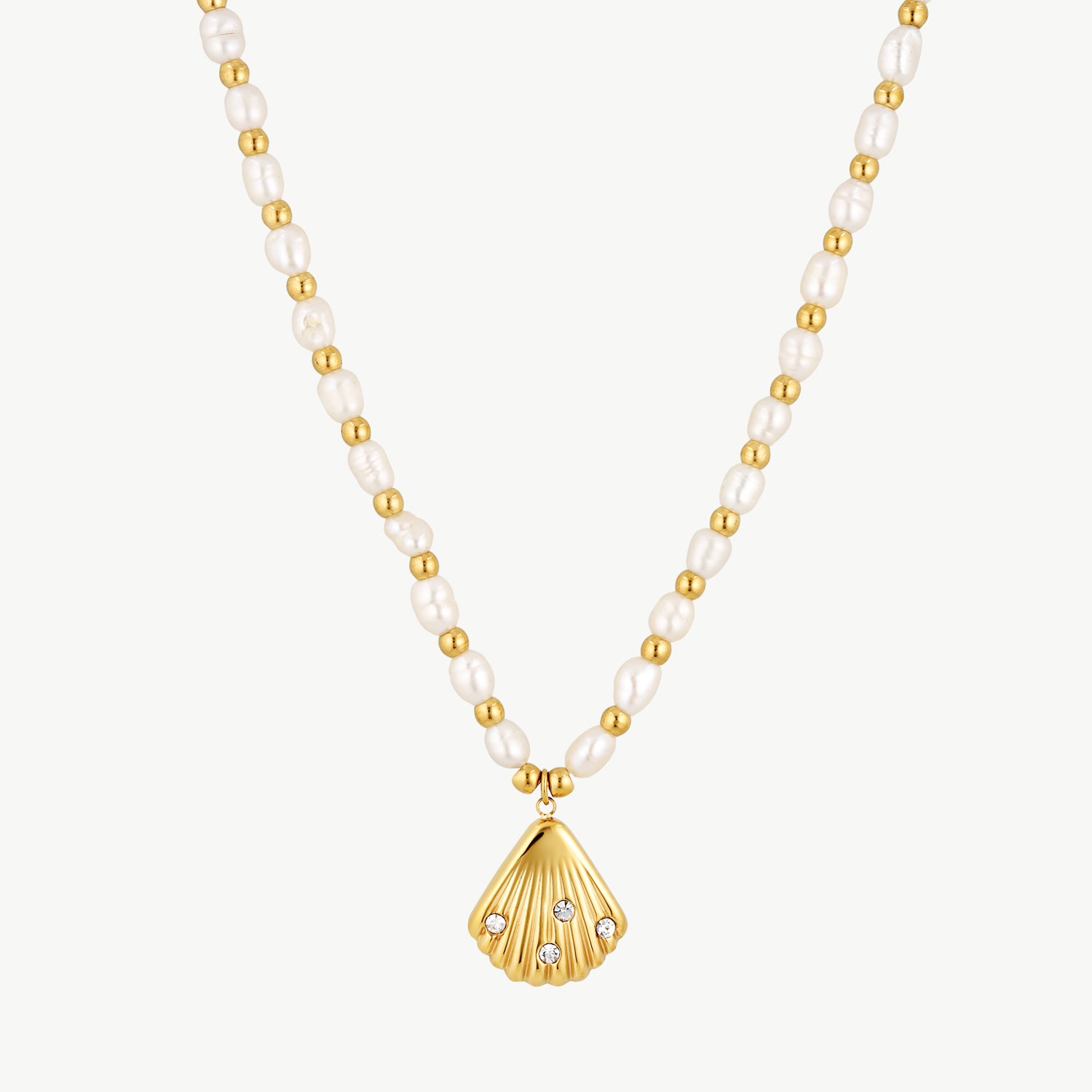 pearl seashell necklace with genuine freshwater pearls, gold beads, and a gold seashell pendant