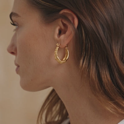 ribbed gold dome earrings for women featuring a bold curved hoop design with fine engraved lines and a shiny gold finish for elegant everyday styling