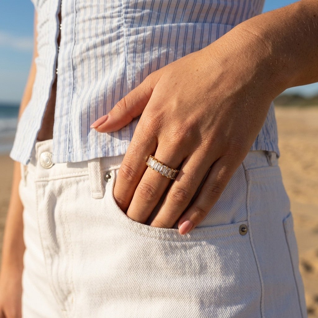rectangular cz band with sparkling clear stones in a polished gold setting, worn on hand