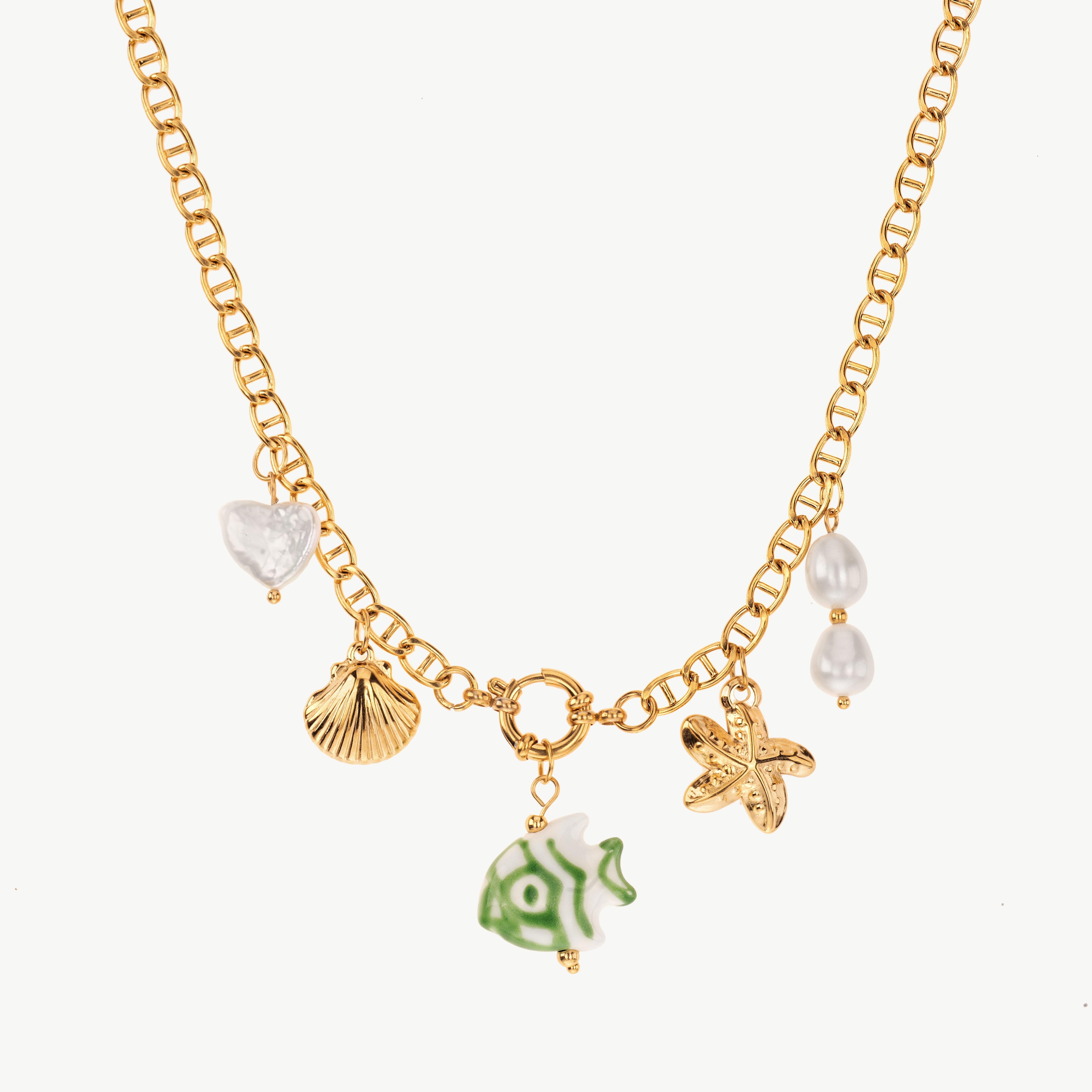 sea charm necklace in gold with mixed ocean charms, beach shell necklace with small pearl and fish details along the chain
