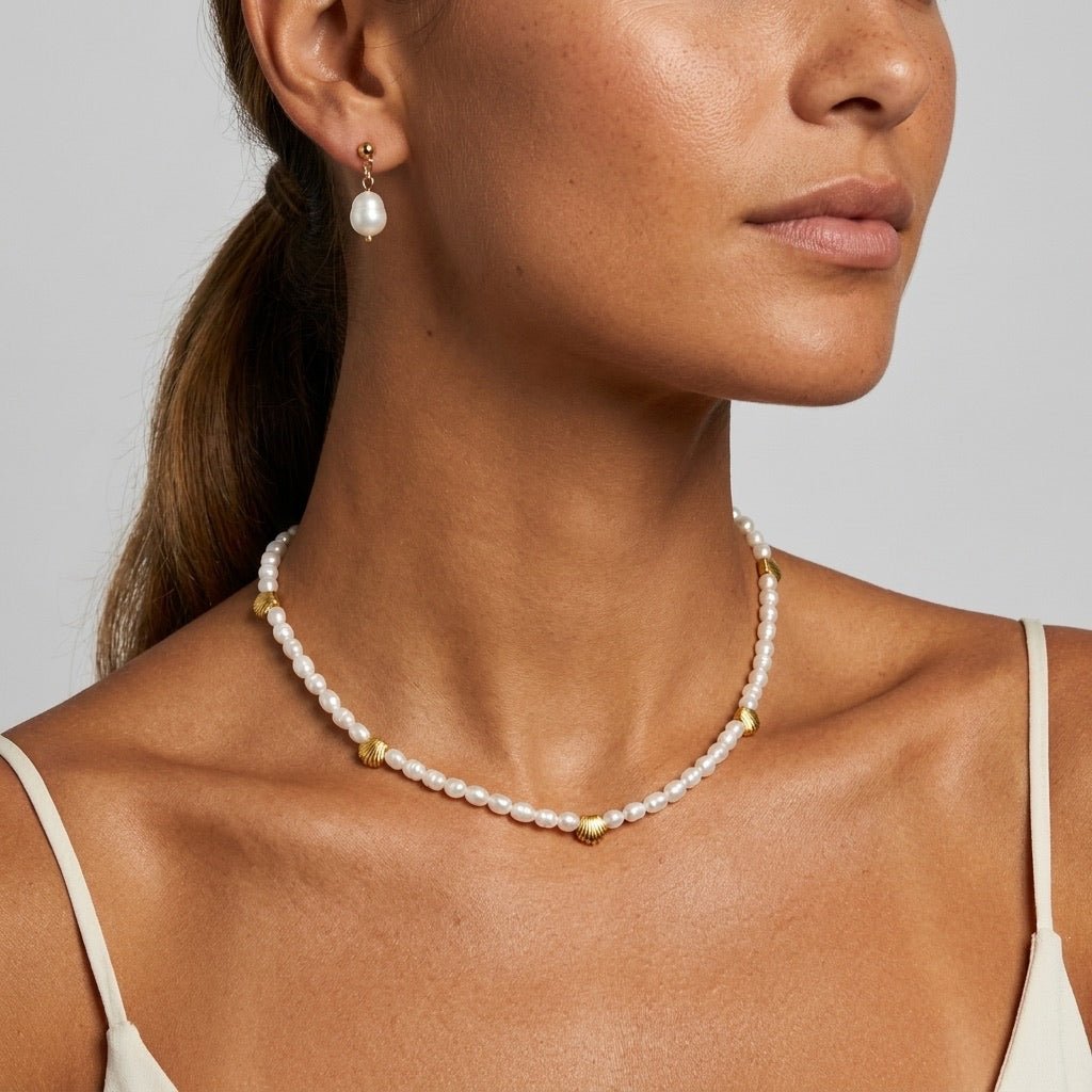 pearl necklace with gold seashell charms and delicate coastal inspired design