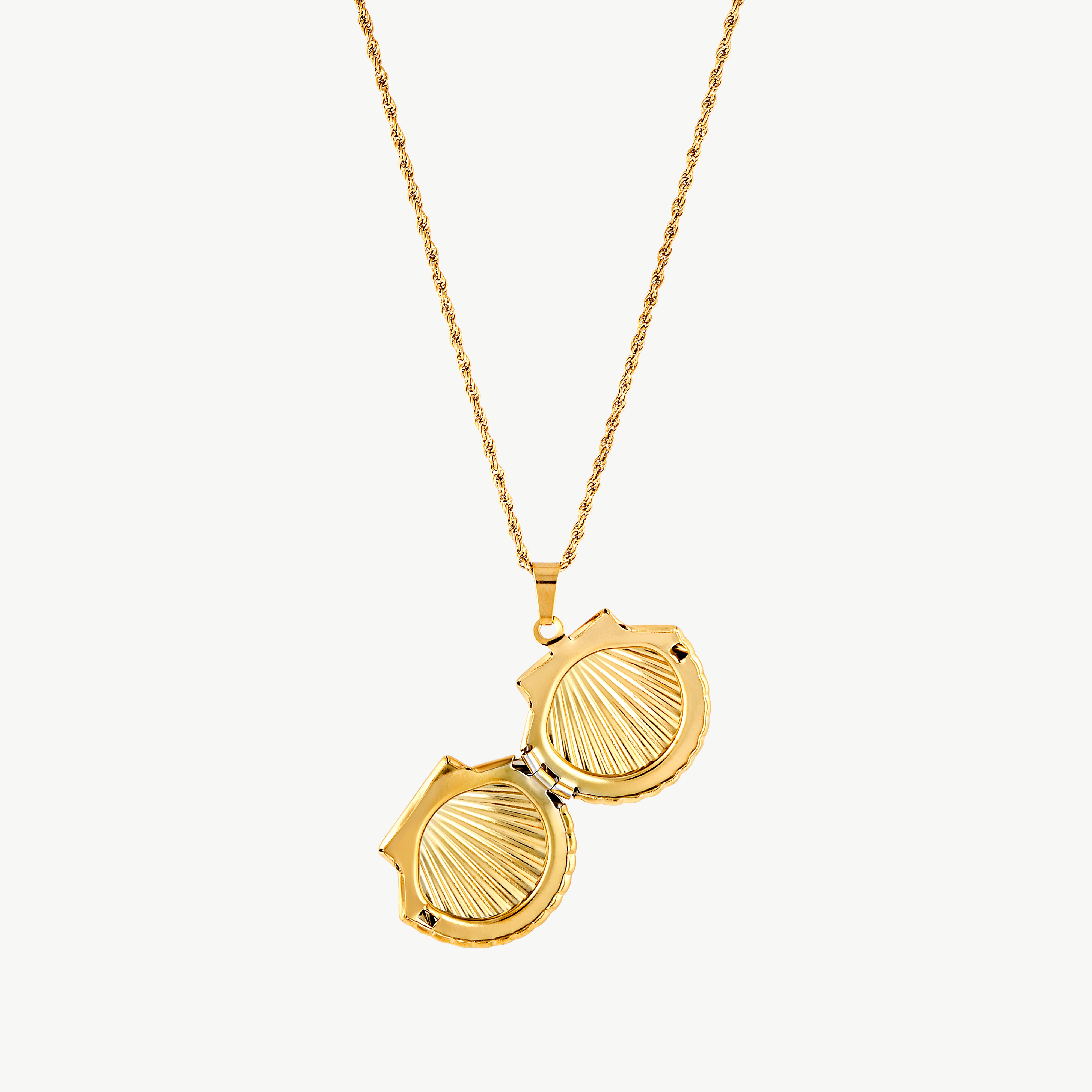 seashell locket necklace with sculptural ridged gold scallop shell pendant suspended from a textured rope chain
