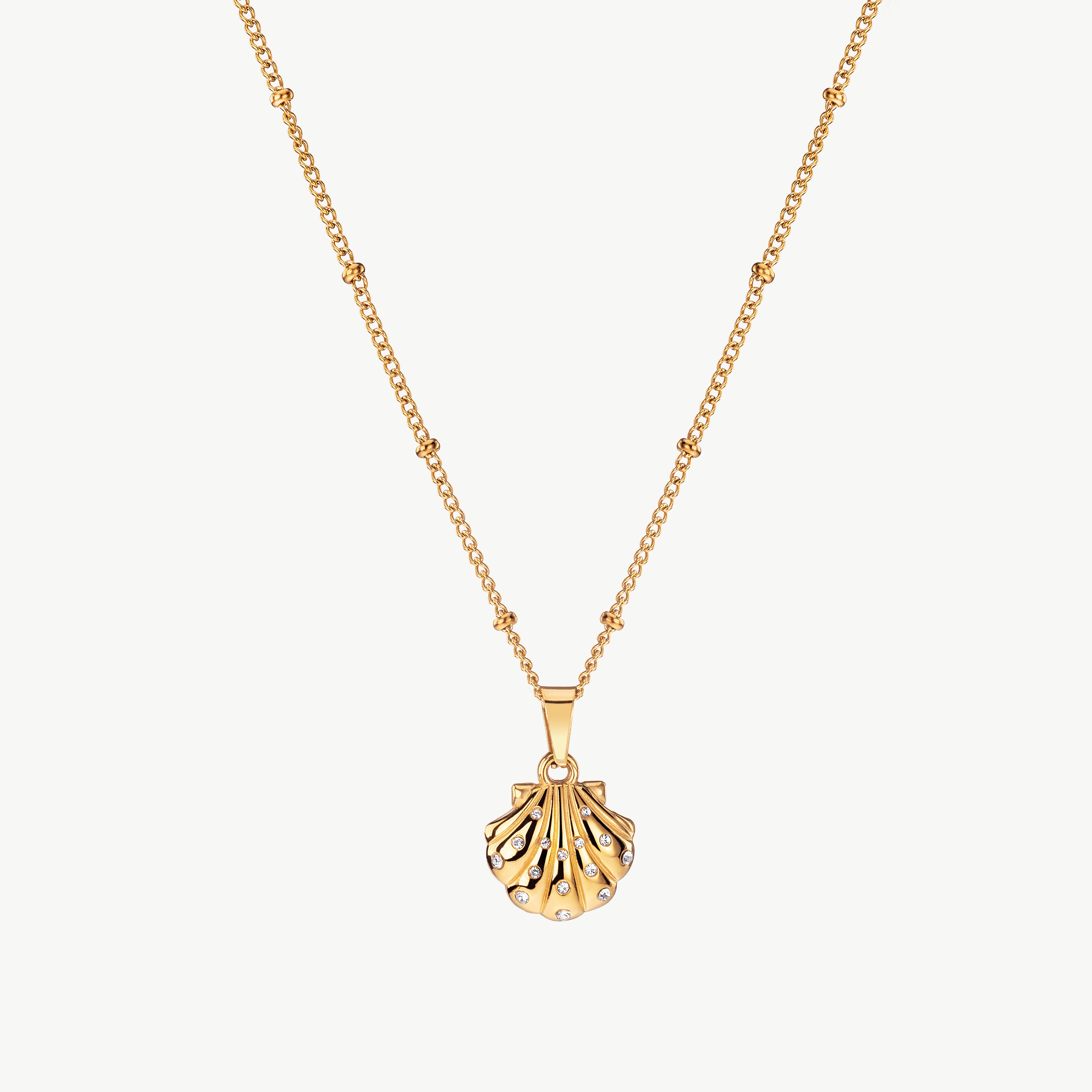 seashell pendant necklace in gold with small shell charm, gold seashell necklace with a delicate coastal-inspired detail