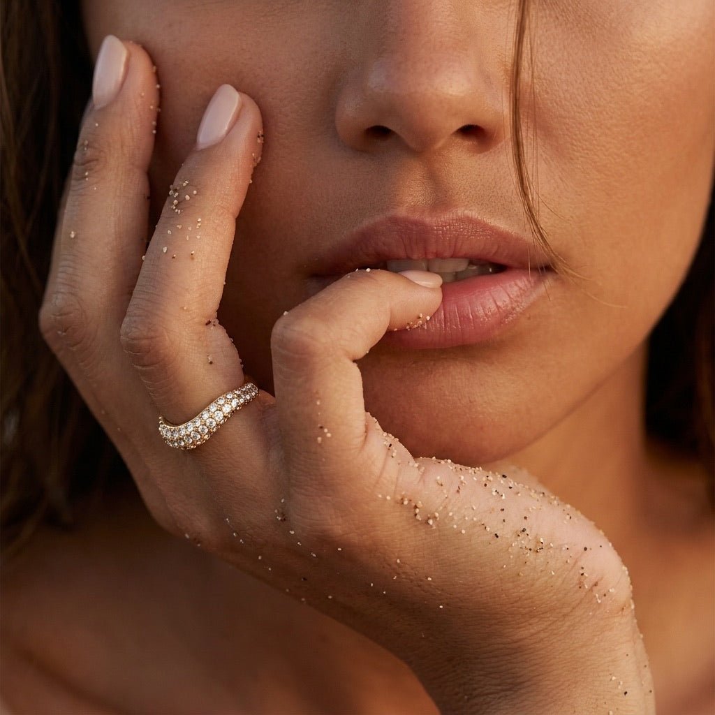 sparkle gold ring with pavé set clear stones and a sculpted wave shaped band