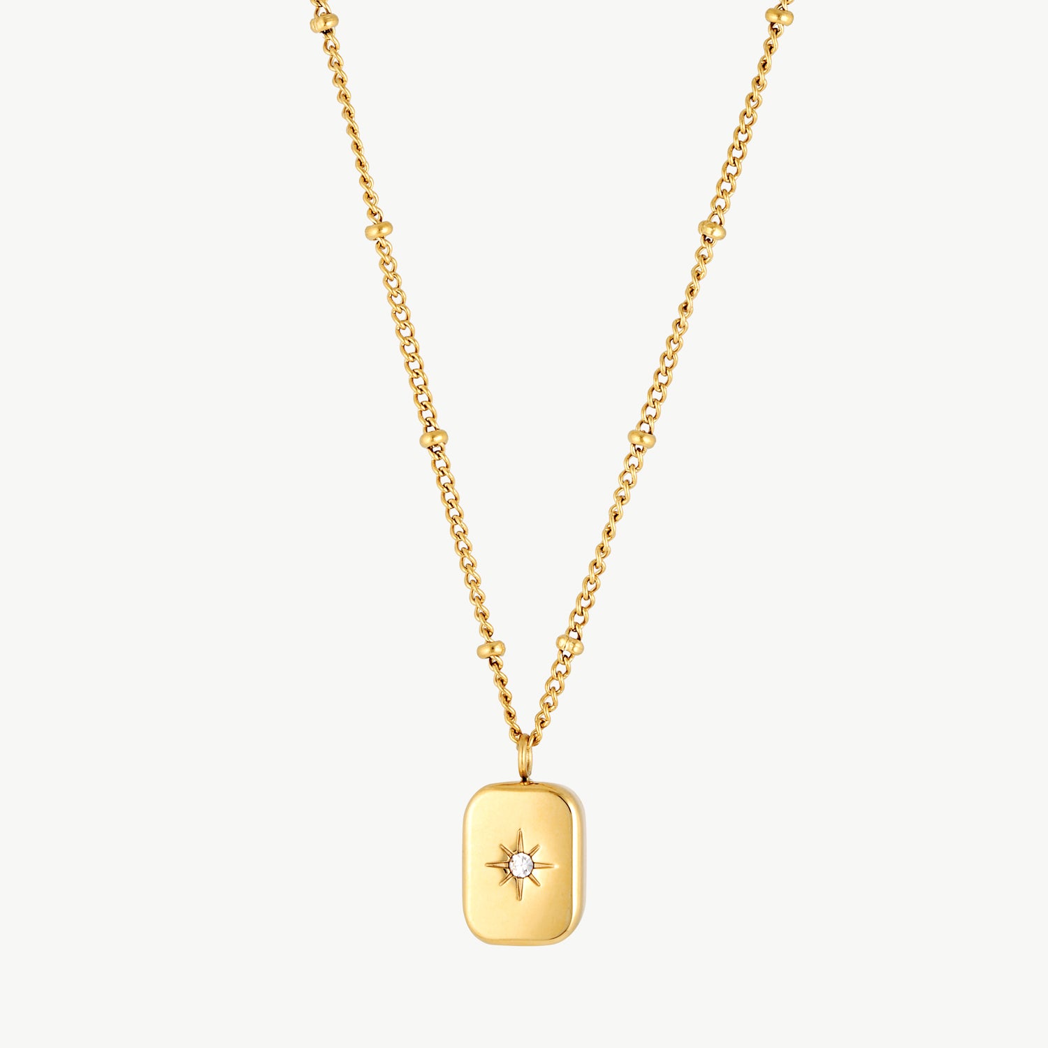 star charm necklace with rectangular pendant and sparkling celestial star detail in gold