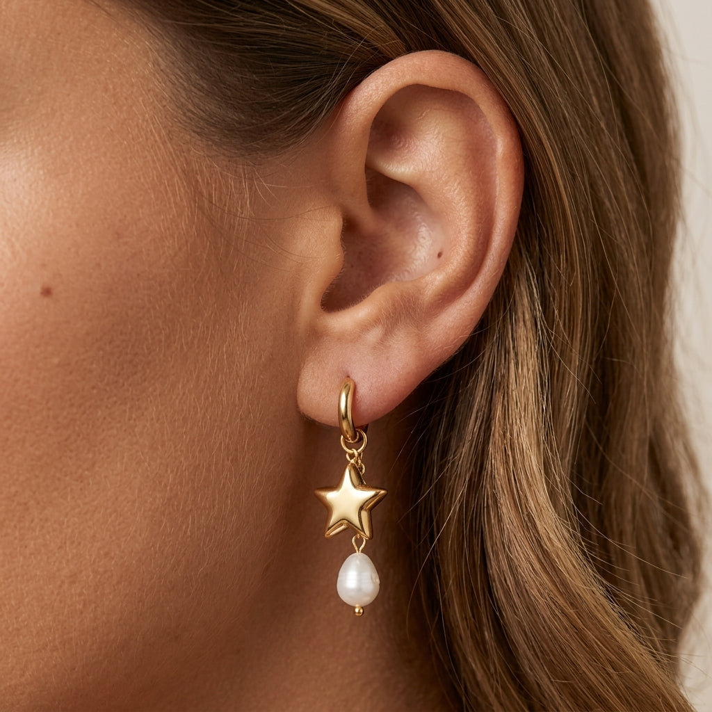star pearl drop earrings featuring shiny gold star pendants with dangling white freshwater style pearls for a chic feminine jewelry look