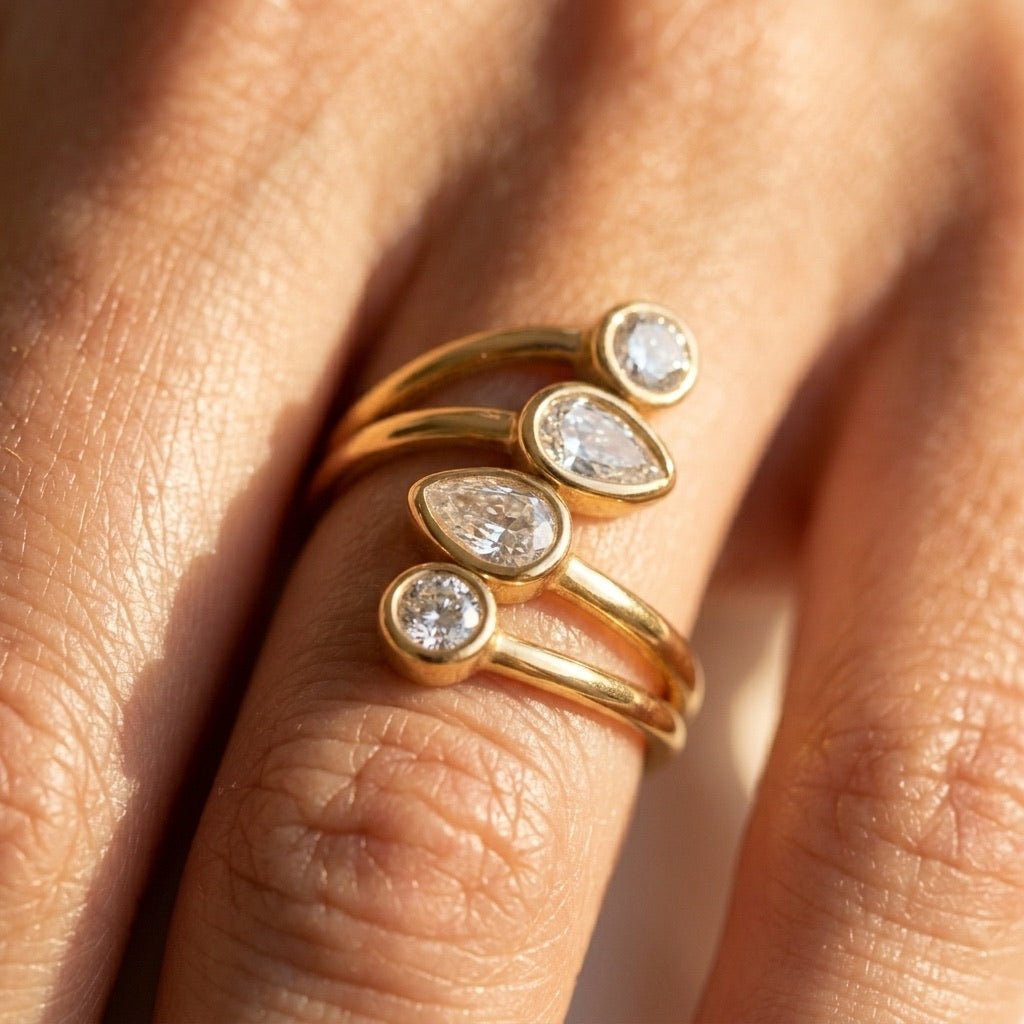 stone cluster gold ring with multiple sparkling stones arranged across a sculptural open band