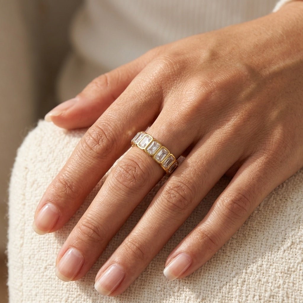 stone set band ring with rectangular cubic zirconia stones and a sleek gold setting