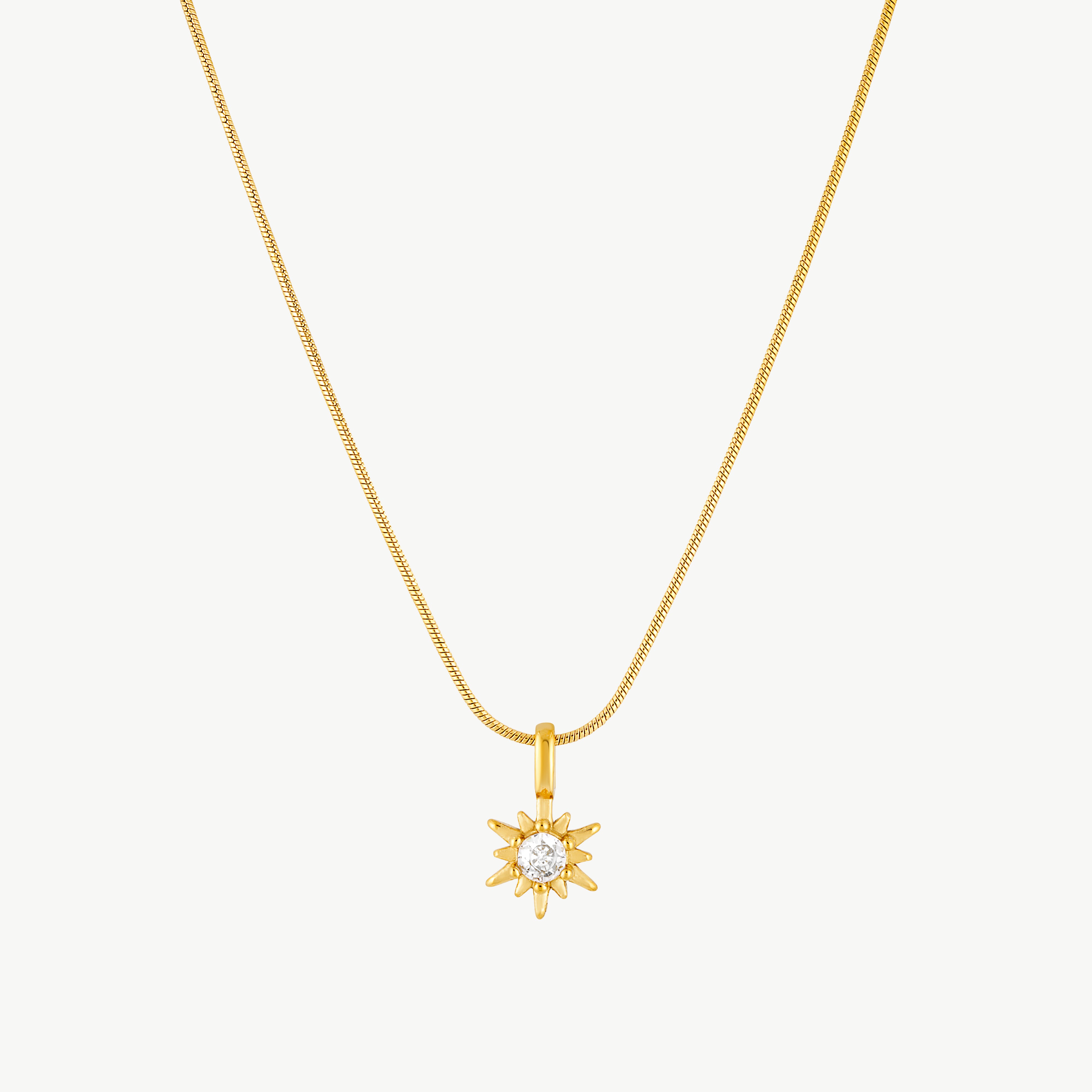 sun pendant necklace with radiant gold sunburst charm and sparkling cubic zirconia center suspended from a sleek gold chain