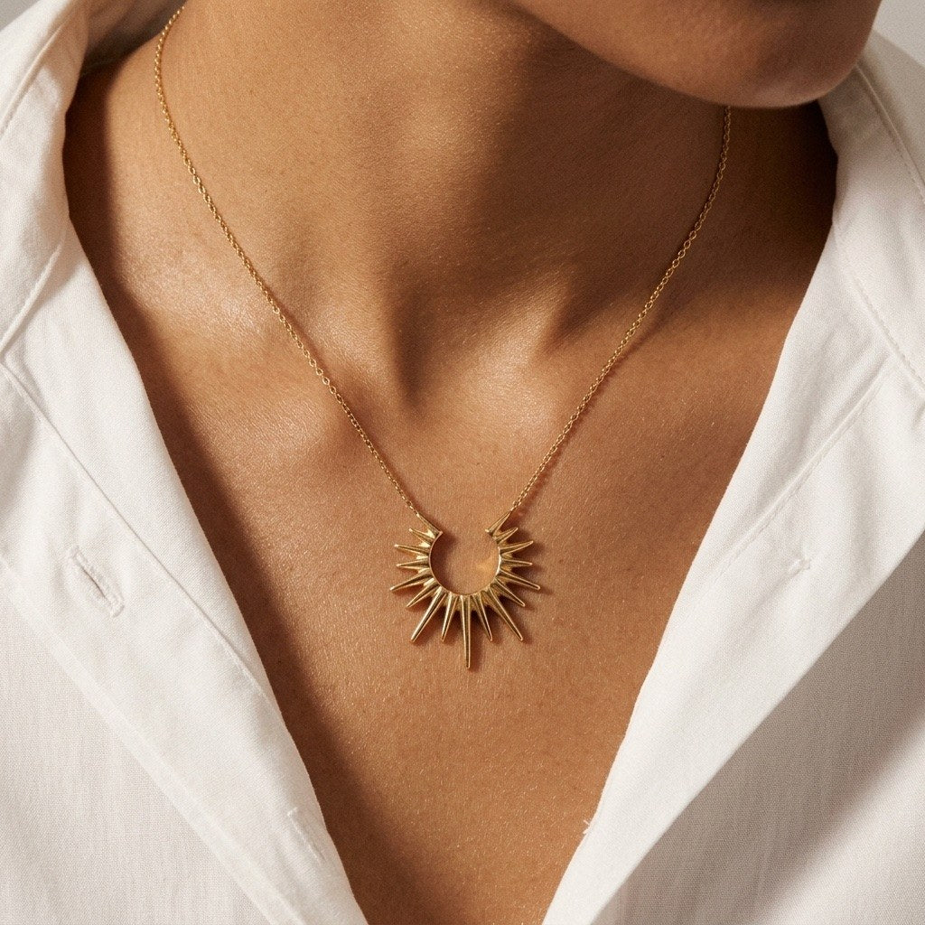 sun ray pendant necklace in gold featuring a bold celestial-inspired design