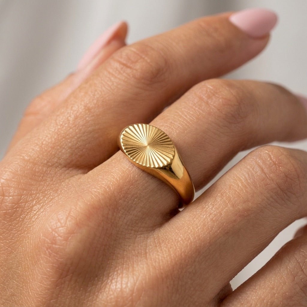 sunburst gold signet ring with textured oval face