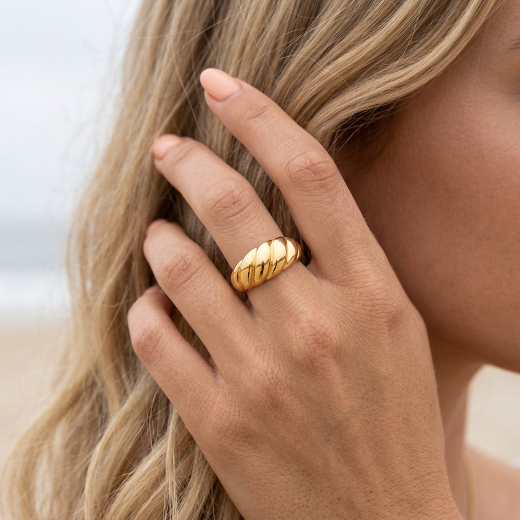 textured gold band with raised diagonal ridges and a smooth polished finish