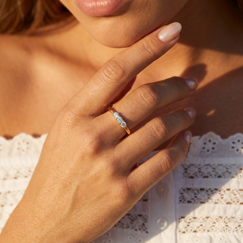 three stone cz ring with round cubic zirconia stones set in a slim gold band