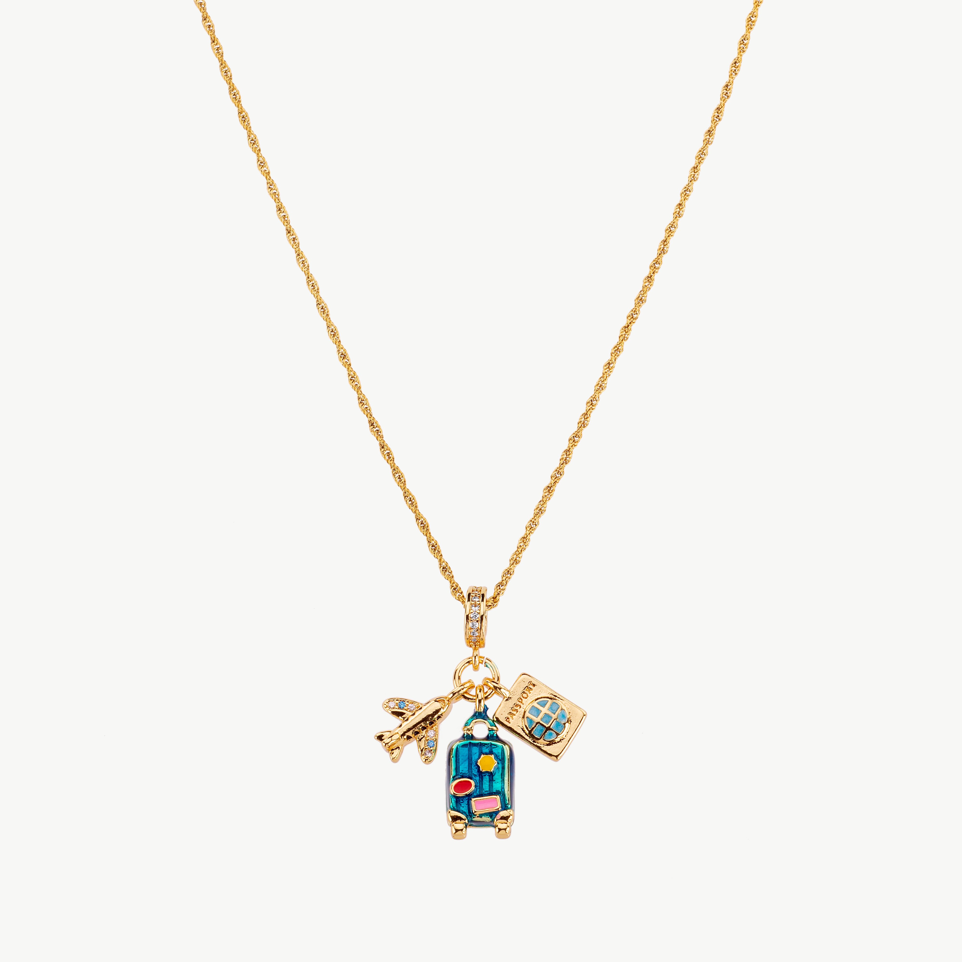 travel necklace in gold with plane charm detail, passport necklace and suitcase necklace elements, wanderlust necklace with polished finish and travel charm necklace
