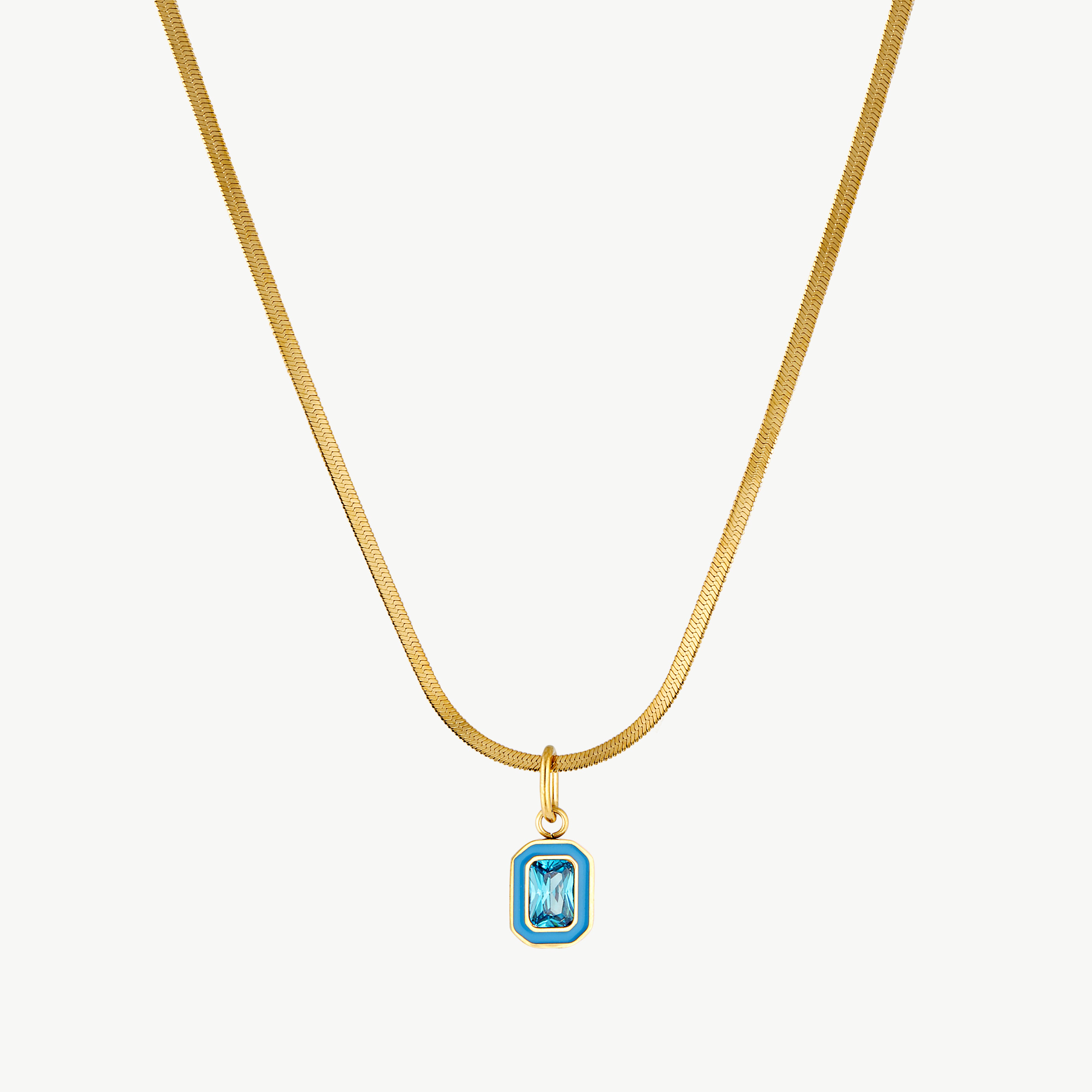 turquoise crystal necklace with gold chain and rectangular turquoise pendant featuring a sparkling cubic zirconia center
