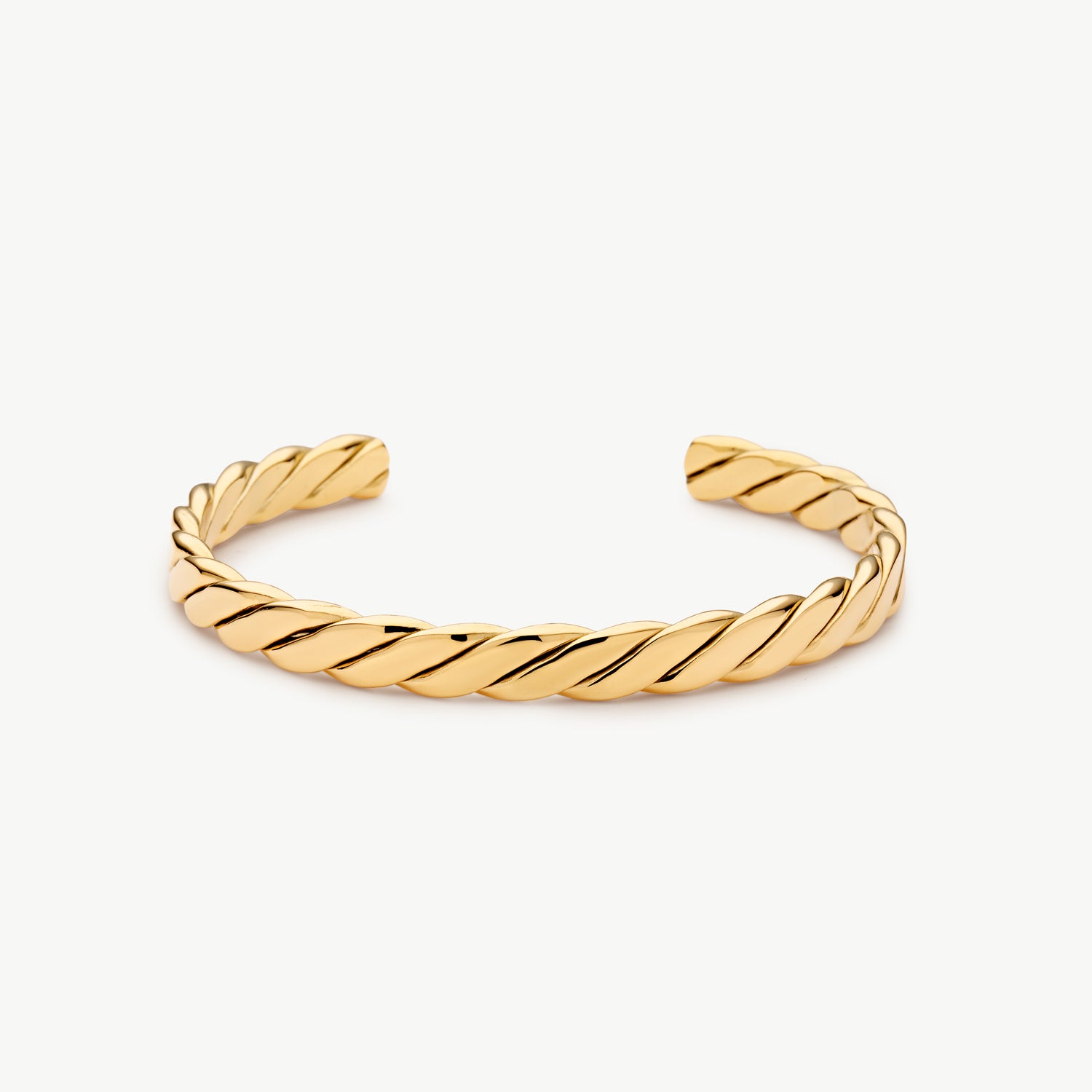 twisted cuff bracelet with a polished gold rope design