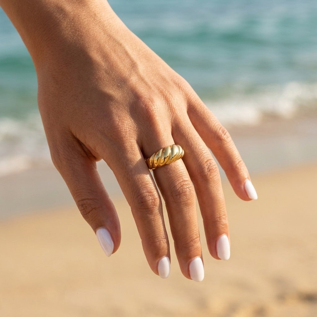 twisted gold band with sculpted diagonal detailing and a bold polished finish