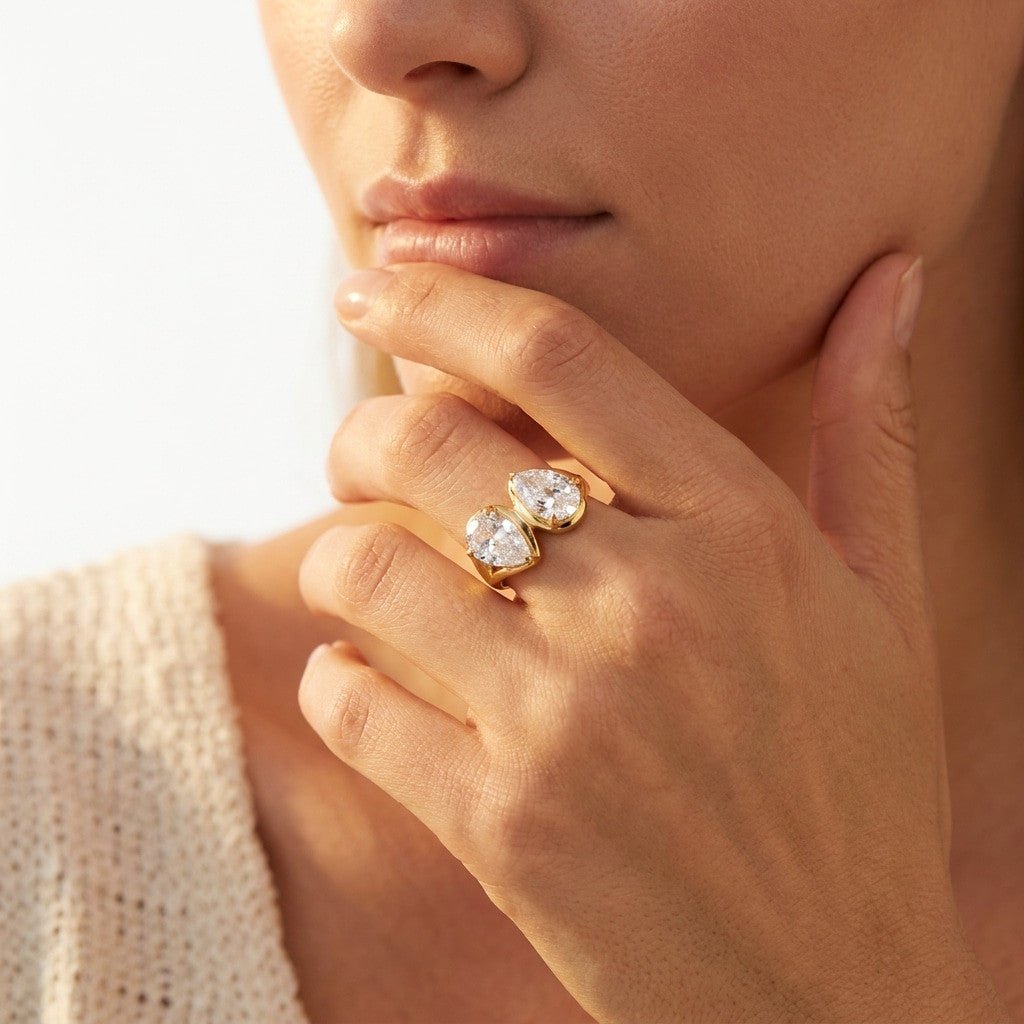 two stone cz gold ring with sparkling pear shaped cubic zirconia stones in a polished open setting