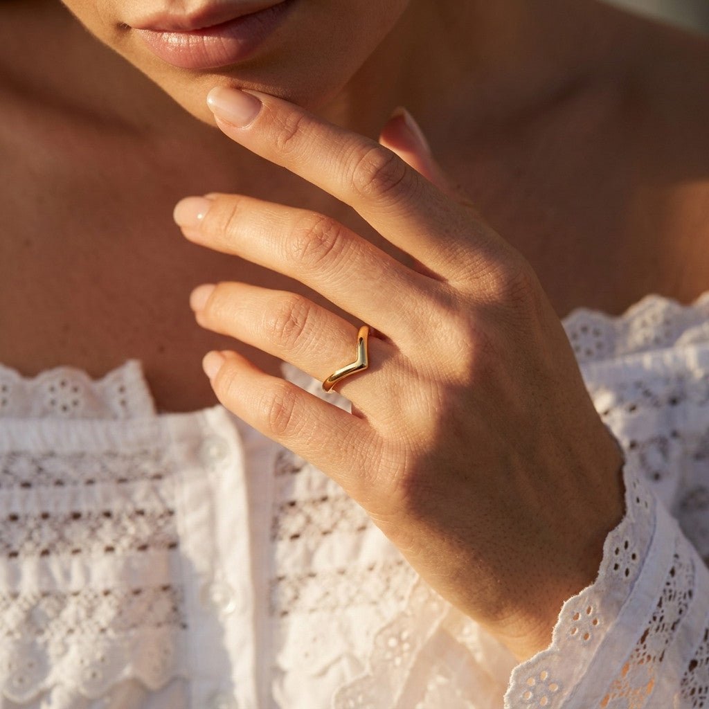 v shaped gold ring with a sleek curved band and polished minimalist finish