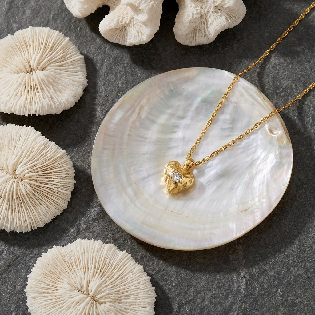 vintage gold heart necklace for women featuring an ornate textured heart pendant with a sparkling clear stone center and twisted gold chain
