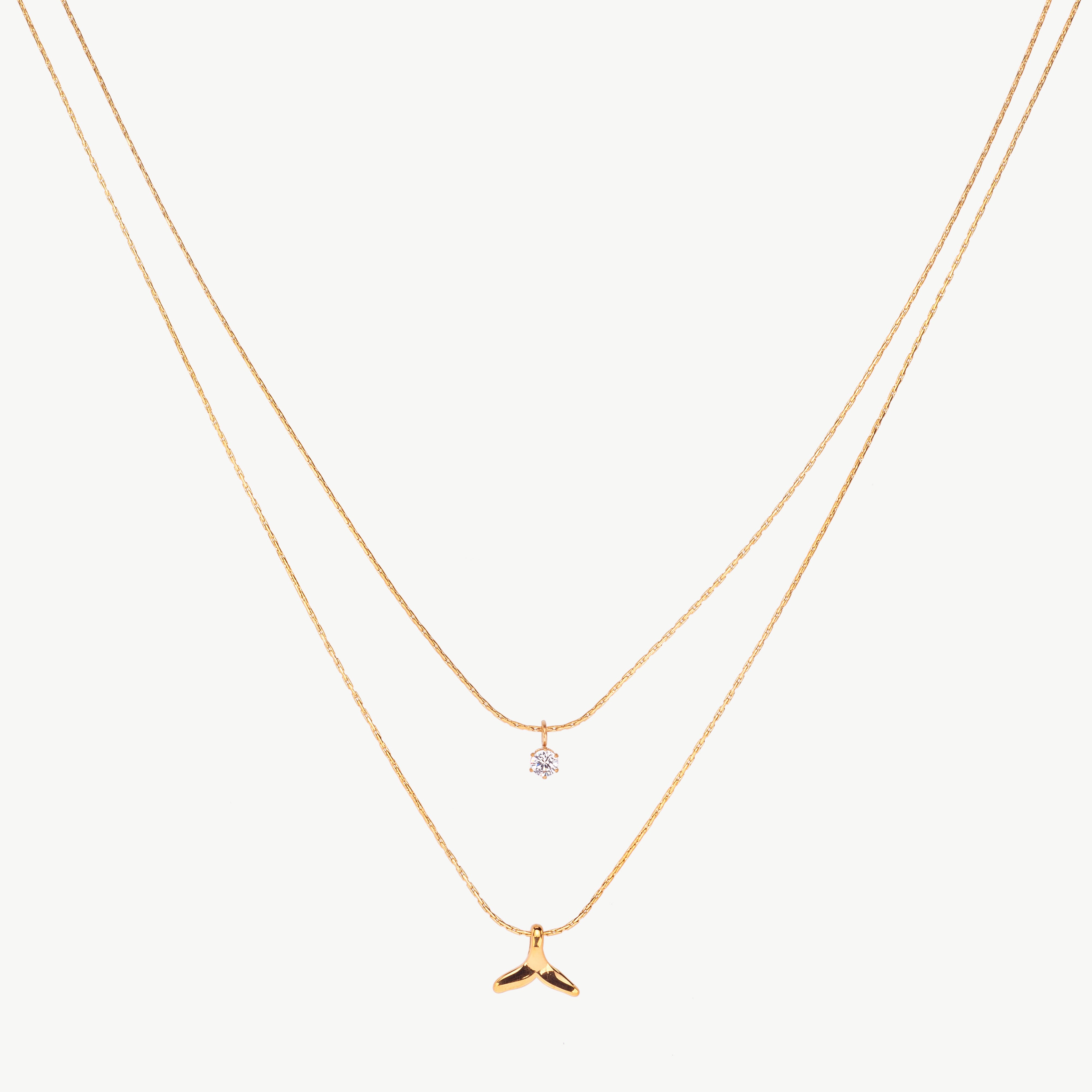 whale tail necklace in gold with smooth ocean themed necklace pendant, minimal ocean necklace with polished finish and fluid curved shape