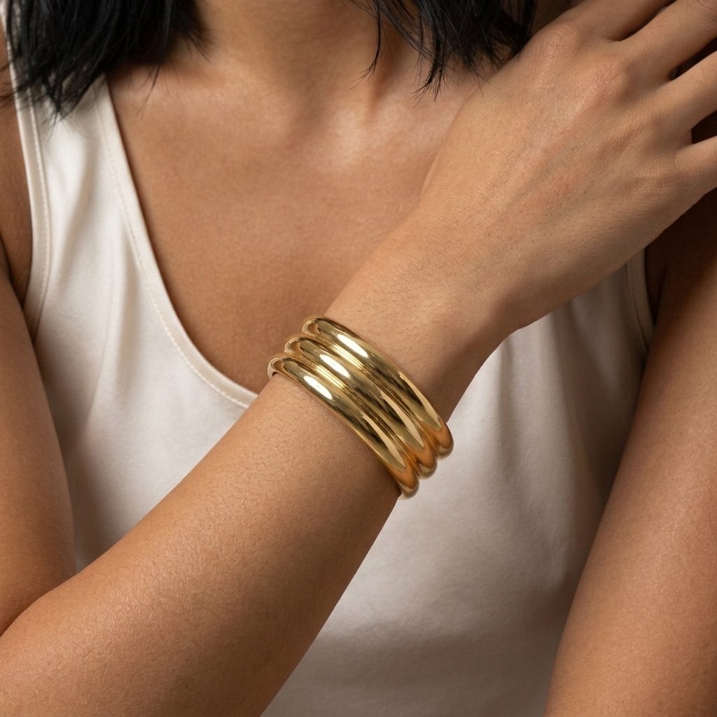 wide gold layered cuff bracelet featuring an integrated multi-band design with a smooth polished finish