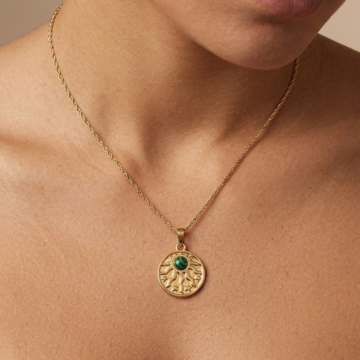 women's gold malachite pendant necklace with a decorative sun motif