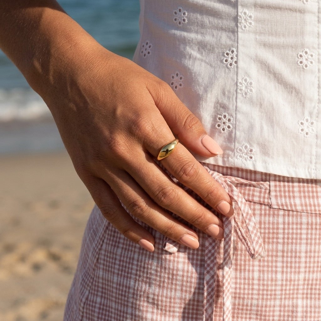 womens gold signet ring with a polished oval top and classic sculpted profile