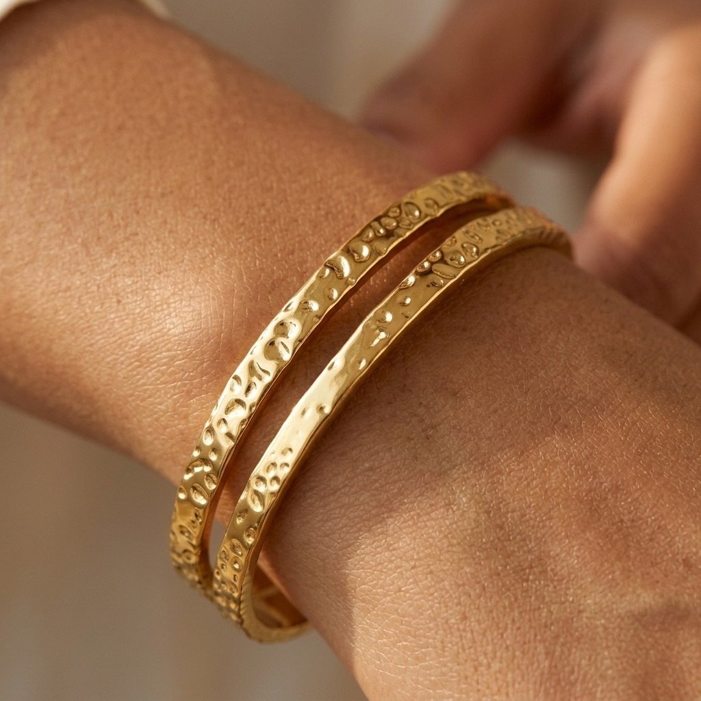 women's hammered gold stacking bangles featuring an elegant artisan textured finish